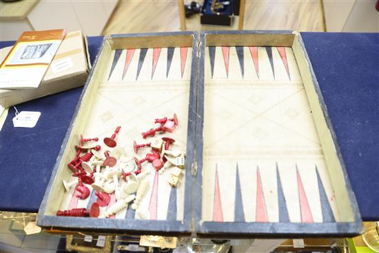 A Backgammon / chess board with stained ivory pieces